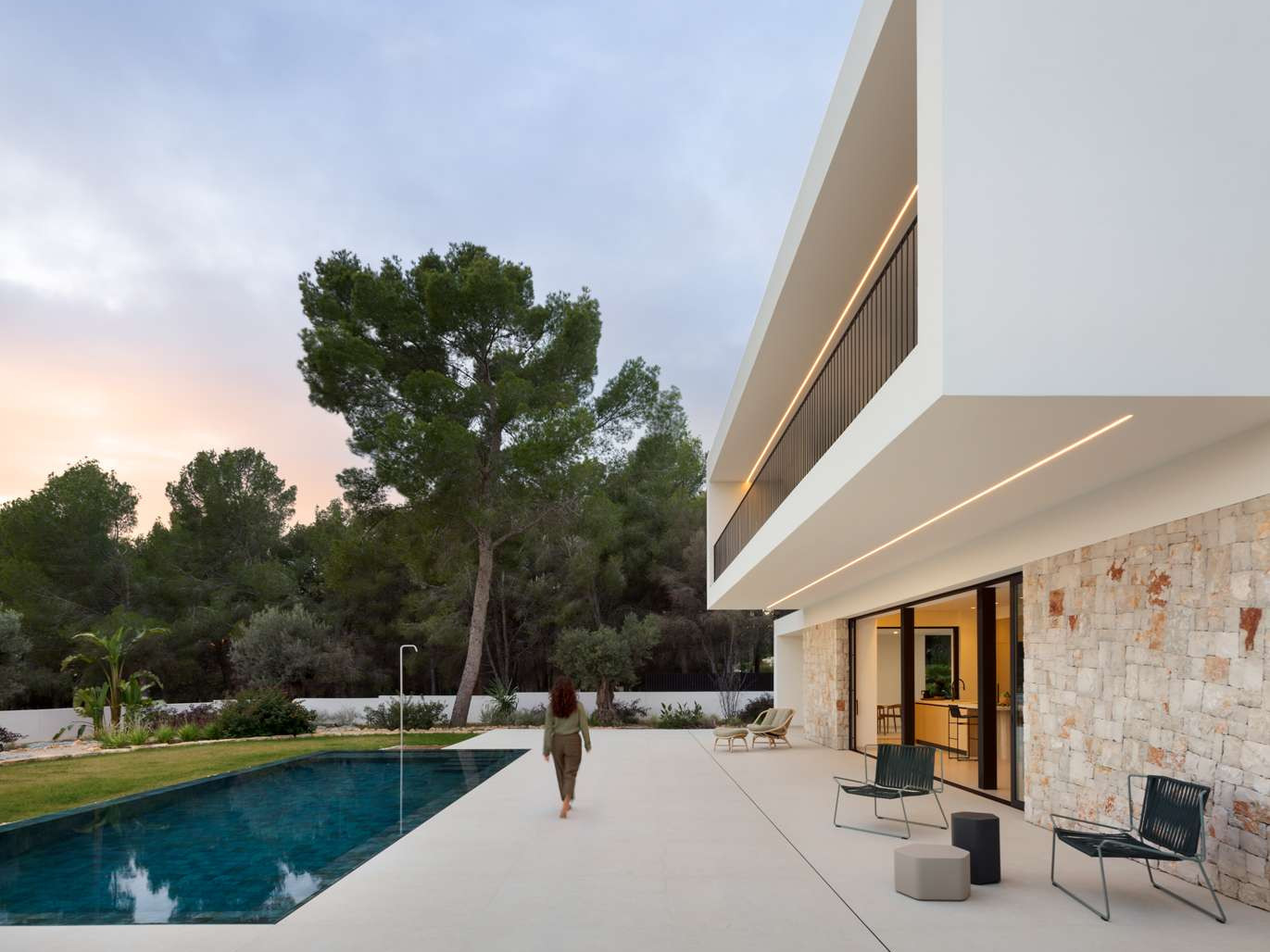 Natural light pours across stone, wood, and ceramic in this modern Mediterranean home, where simplicity is anything but empty.