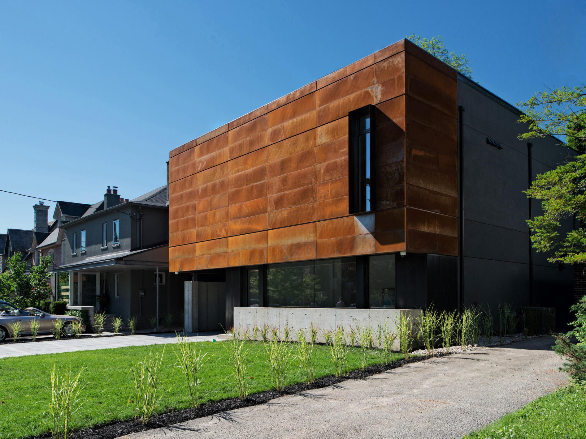 A striking corten steel facade gives this Toronto home a sculptural, textural presence while blending seamlessly into its urban setting. Designed by Tact Design, it sets the tone for the home's bold yet elegant aesthetic.