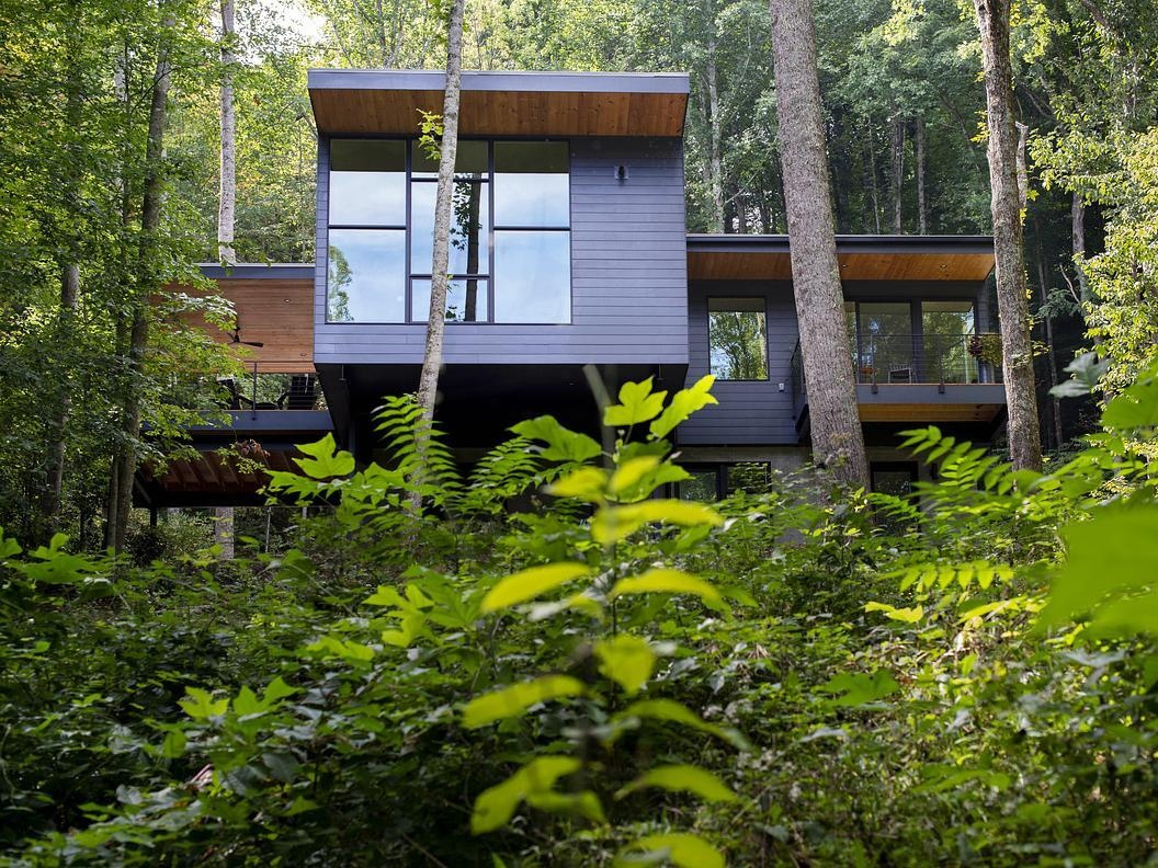 A quiet, compact home nestled in the North Carolina woods, designed to blend into the forest and open up to valley views.
