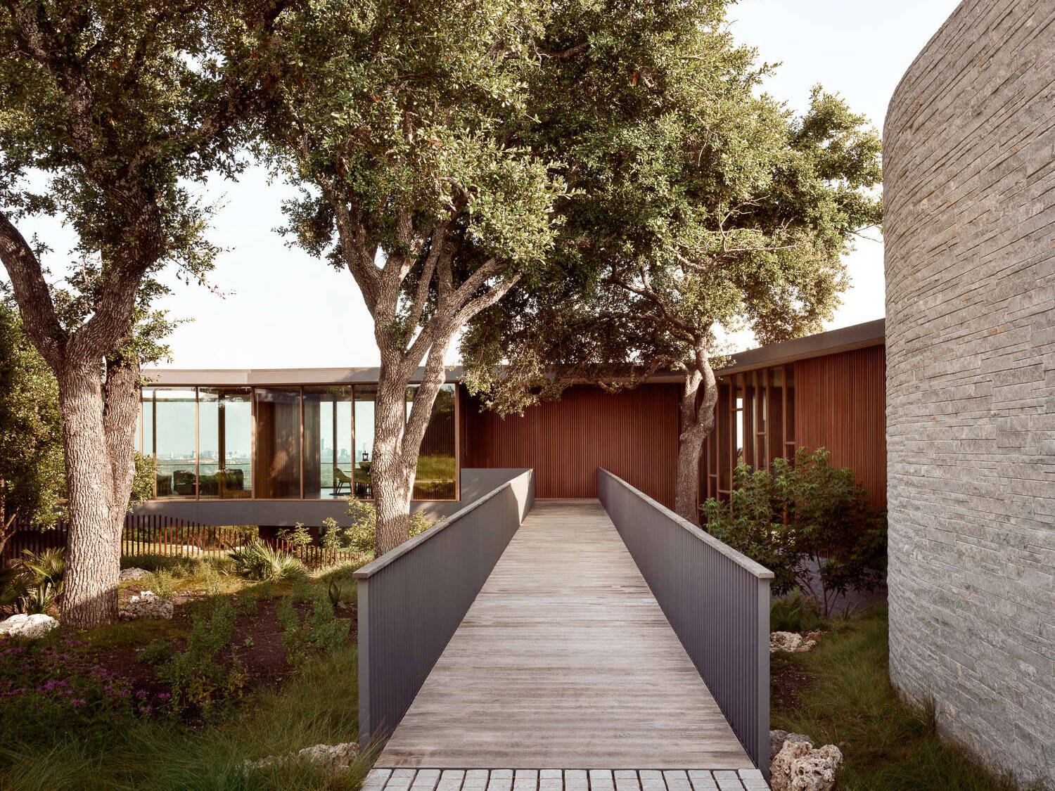 Natural stone, wood, and steel define this sustainable hillside home.