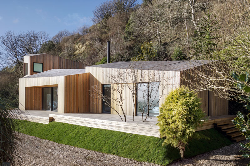 A striking coastal holiday home clad in rough-sawn larch, with pod-like forms that twist and shift to echo the landscape.