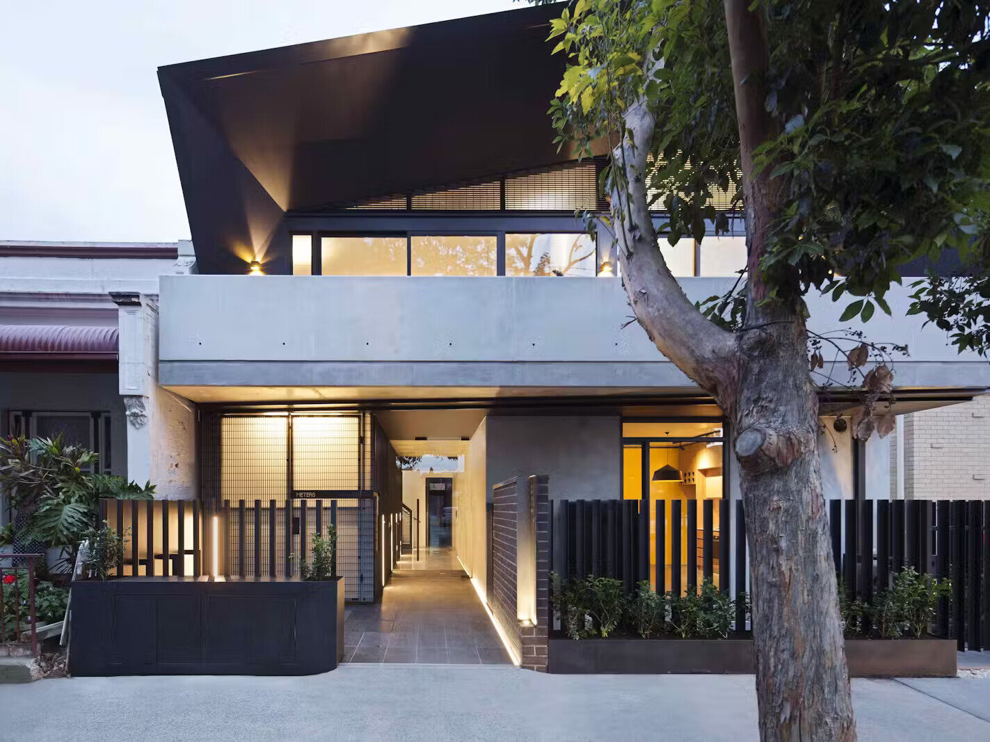 A modern apartment building in Melbourne with two welcoming entrances, one private, one shared, designed to balance individuality and community.