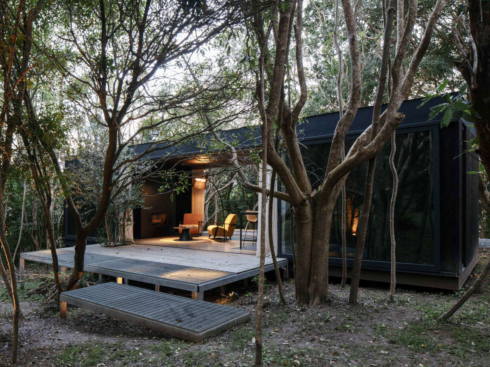 Prefabricated with precision, this small home sits lightly on the terrain, leaving the natural setting untouched.