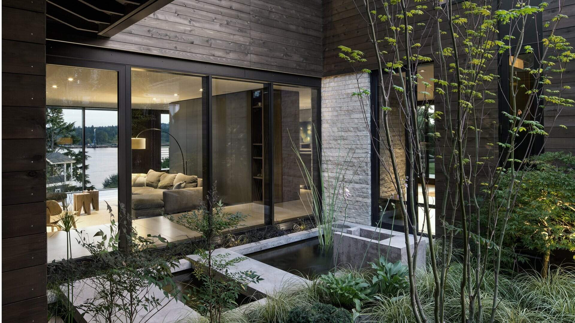 This renovated midcentury home  blends 1960s charm with modern updates, featuring floor-to-ceiling glass, radiant heating, and a tranquil central courtyard.