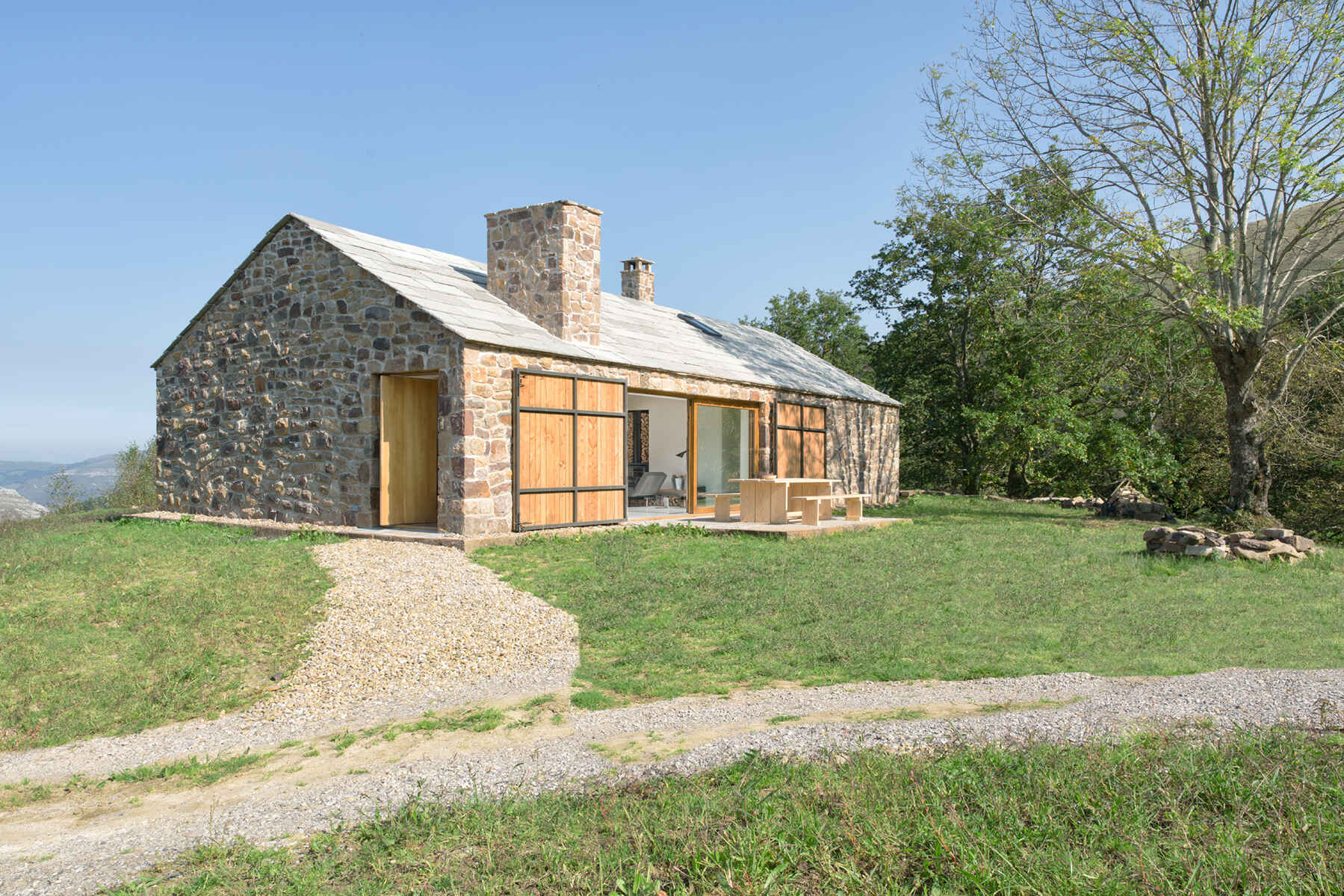 Spanish architect Laura Alvarez returns to her roots to design a serene mountain cottage inspired by childhood memories.