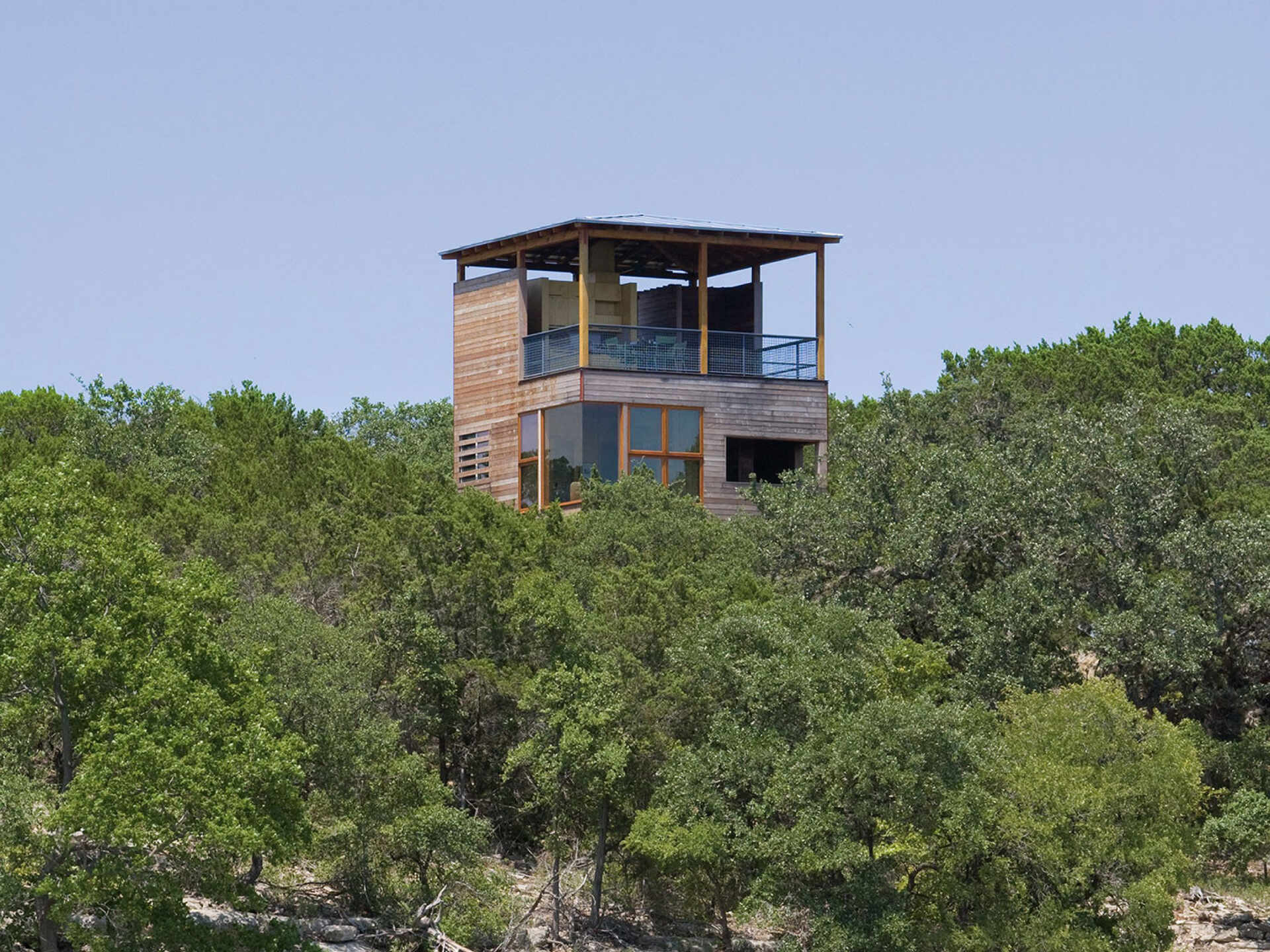 Inspired by the layers of a log, the Tower House blends natural materials and thoughtful design to rise gracefully above the forest.