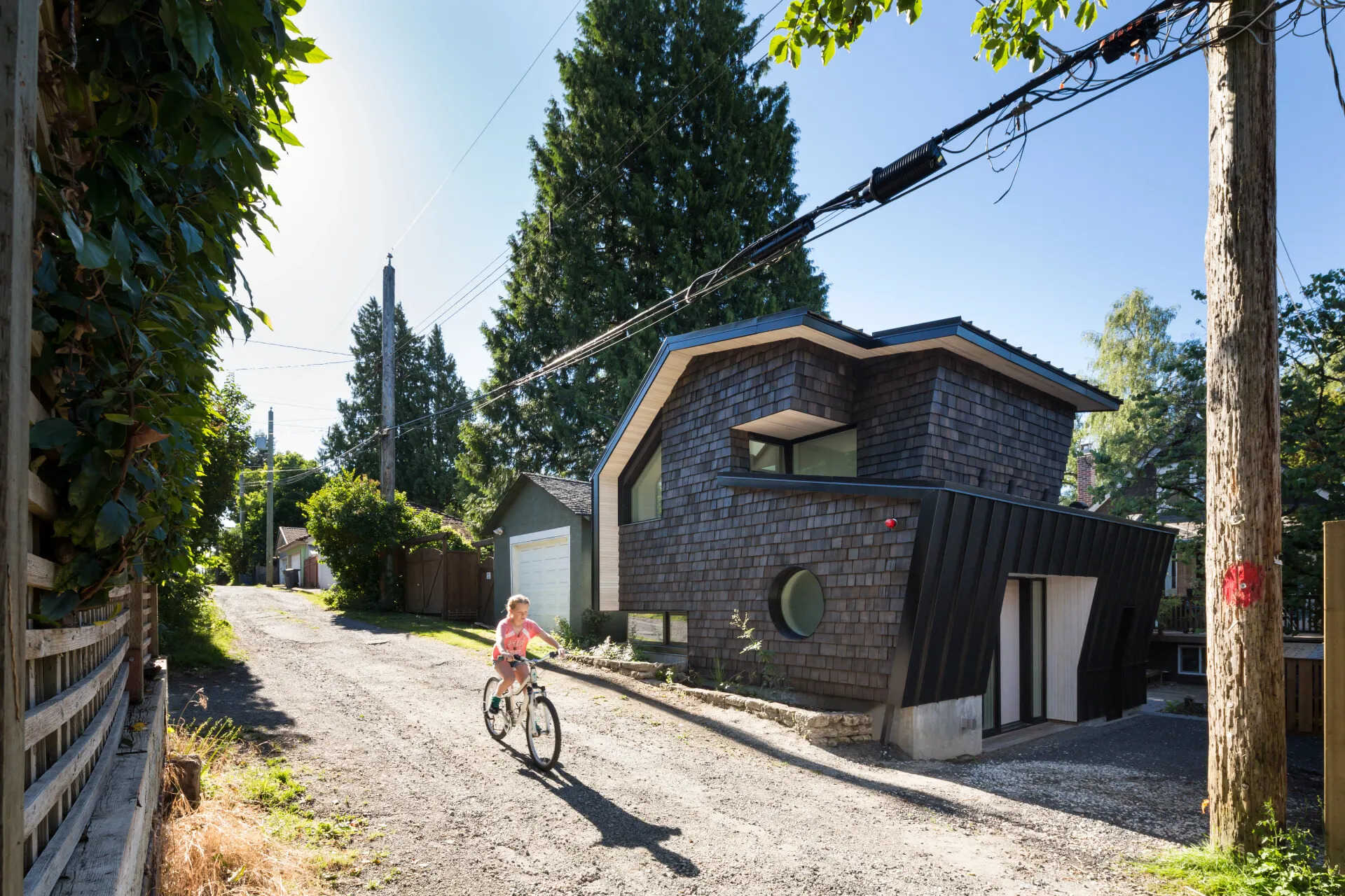 A striking shingle-covered laneway home in Vancouver blends Japanese tradition with modern design.