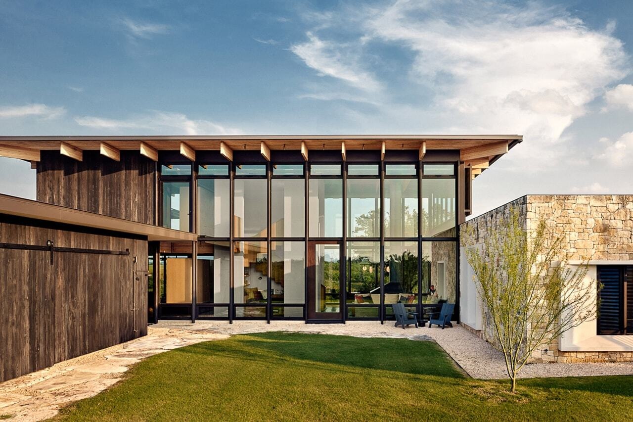 Locally sourced limestone, Douglas fir and shou sugi ban create a rustic yet refined exterior that blends this home into the Texas landscape.