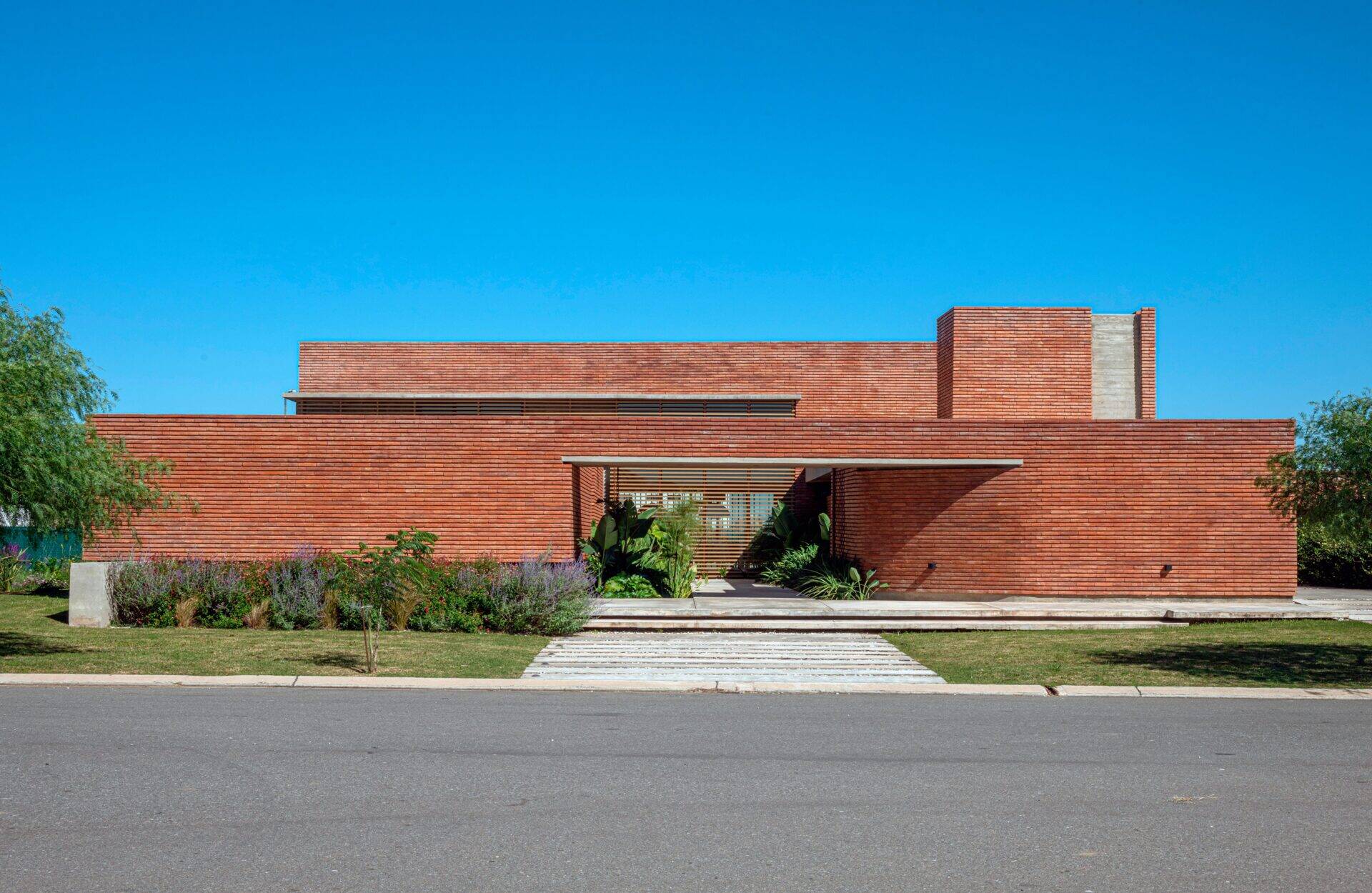 A brick family house in Córdoba designed around courtyards, light, and the experience of arrival, where everyday entry becomes a meaningful moment.