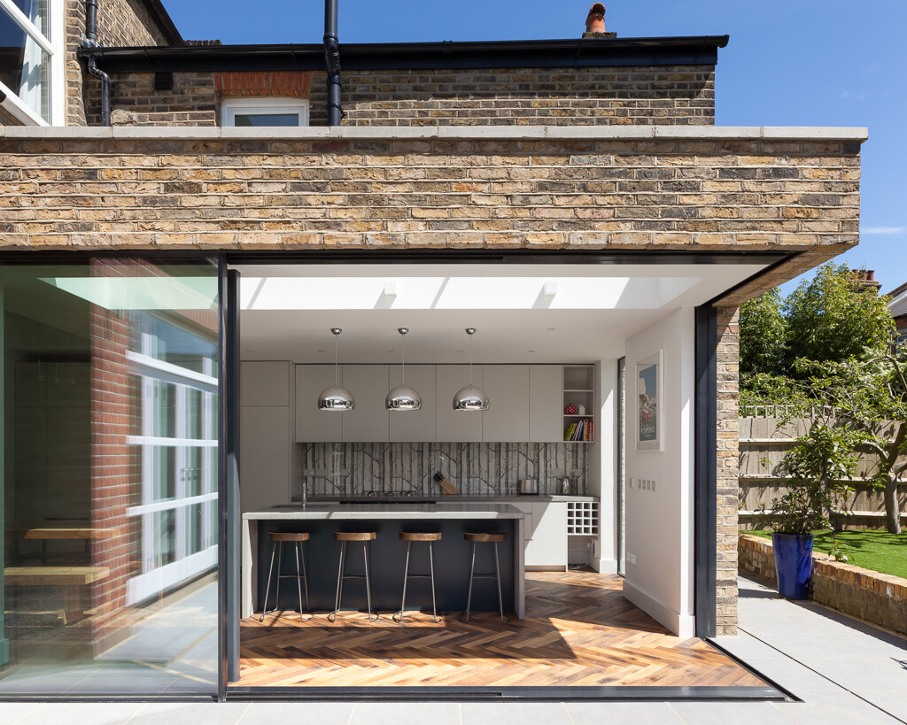 A subtle rear extension using reclaimed brick creates more space while preserving the home’s historic character.