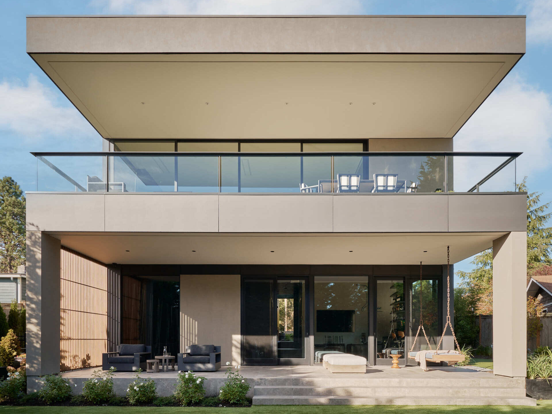 The lake-view terrace connects indoors and outdoors seamlessly, while layered screens soften views and keep the space airy.