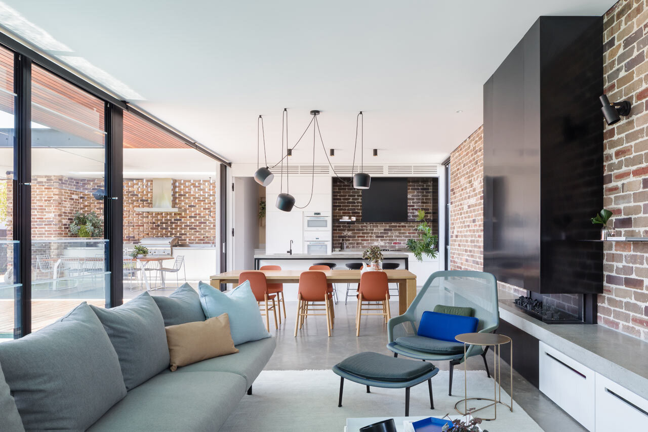 A recycled brick feature wall adds texture and warmth to the open plan living, dining and kitchen area.