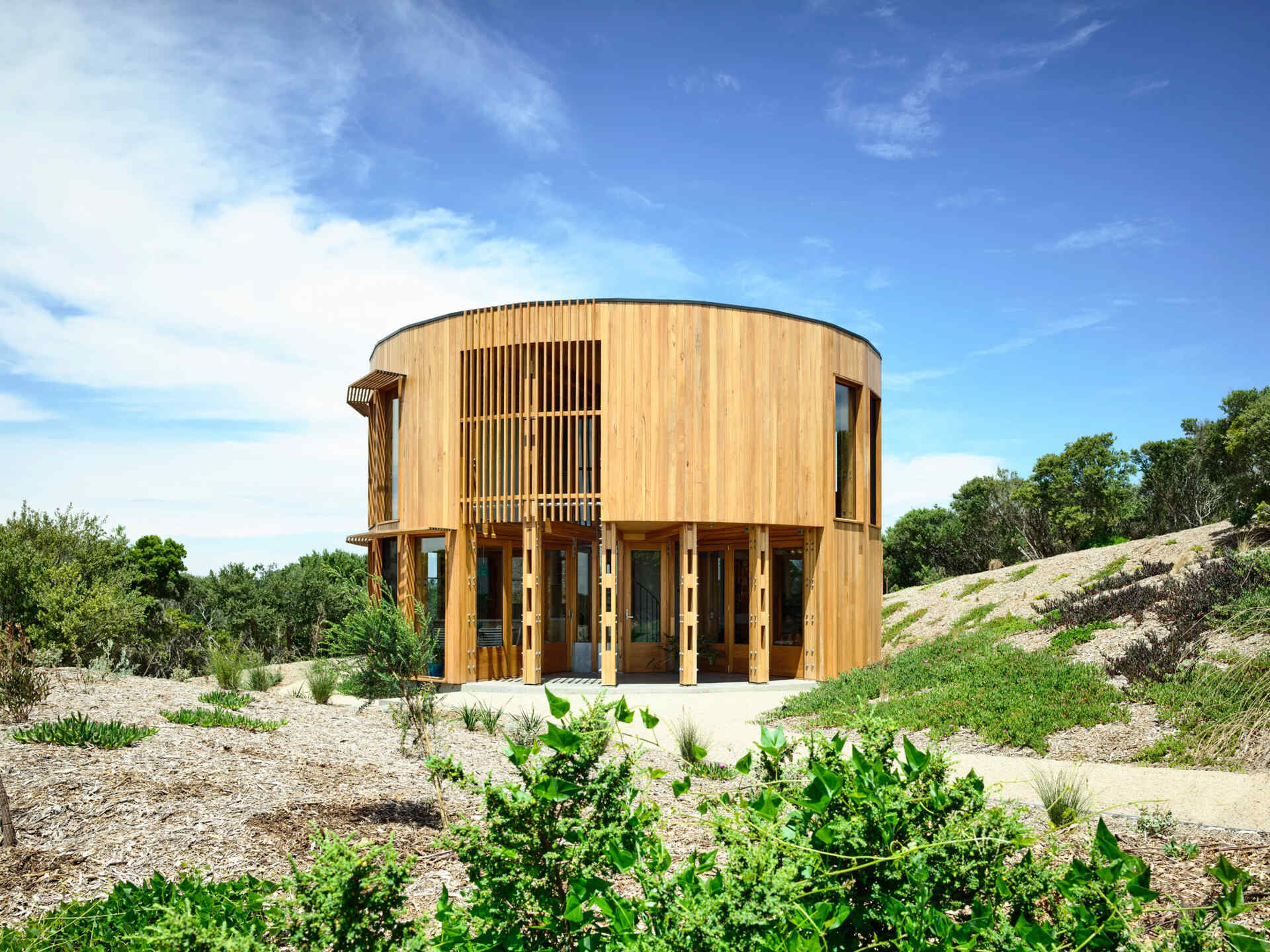 A compact circular beach house on the Mornington Peninsula designed for slow living and simplicity by the sea.