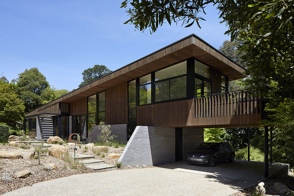 A sustainable split-level home in Melbourne designed for bushland living, featuring Ironbark cladding and innovative Timbercrete blockwork that blends strength with warmth.
