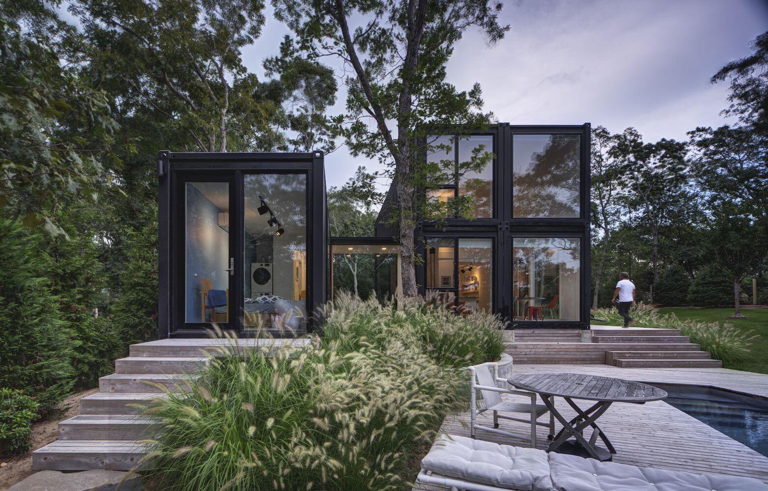 A modern shipping container home designed for a family of five on a wooded New York site. Installed in just two days, this 4-bedroom prefab house proves industrial materials can feel warm and livable.