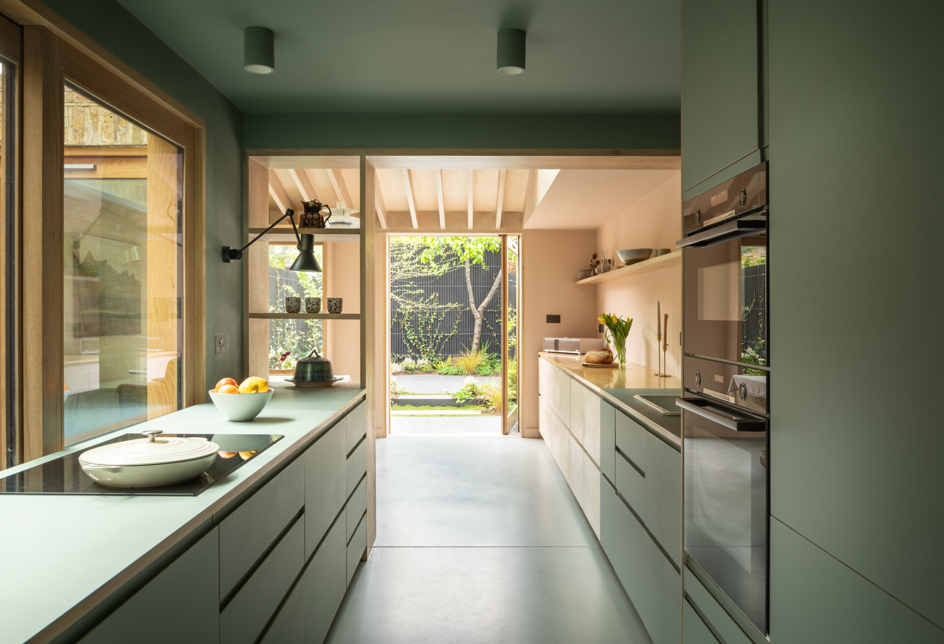 This bothy-inspired addition by Turner Architects transforms a small urban garden edge into a solid, material-driven kitchen and sitting space.