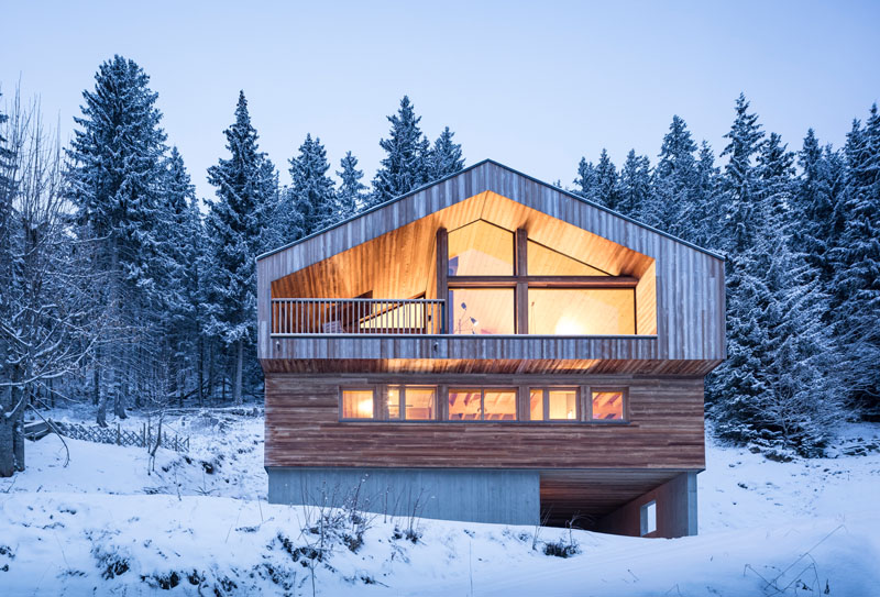 Discover how Studio Razavi Architecture designed a contemporary mountain home in Manigod, France, with bedrooms below, living spaces above, warm natural materials, and panoramic Alpine views.