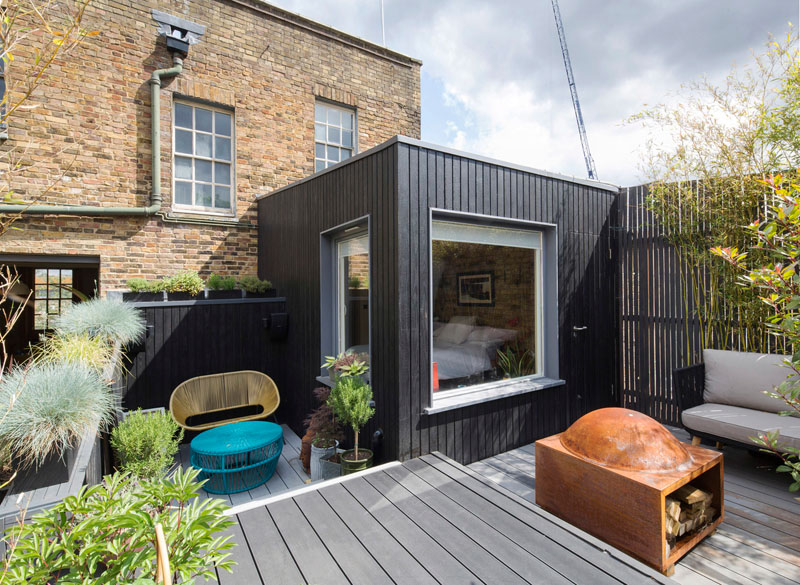 A North London period home by Nicholas Kirk Architects gets a bright refurbishment and a new charred timber bedroom extension overlooking an outdoor living room.
